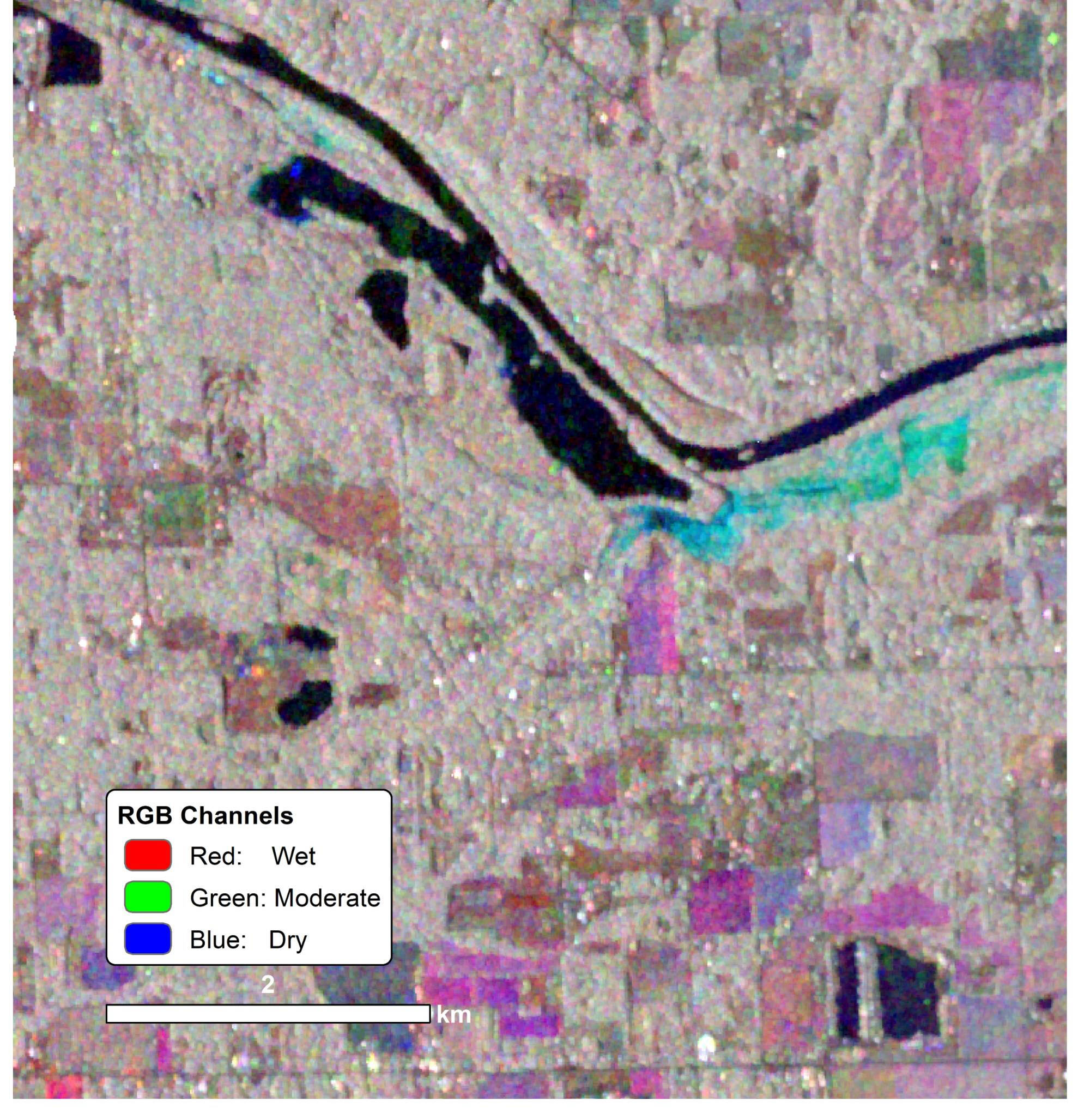 A satellite image with false color overlay indicating soil wetness near a river.
